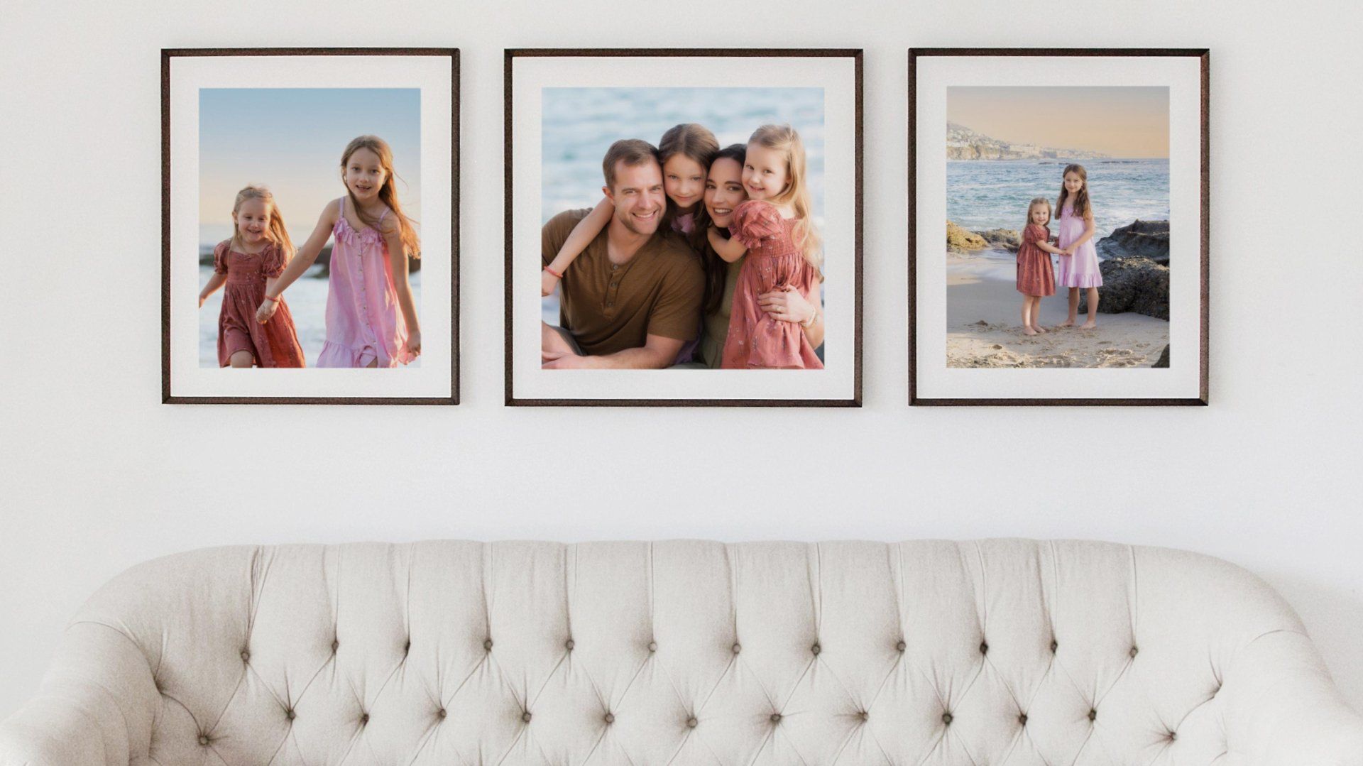 Three pictures of a family are hanging on a wall above a couch.