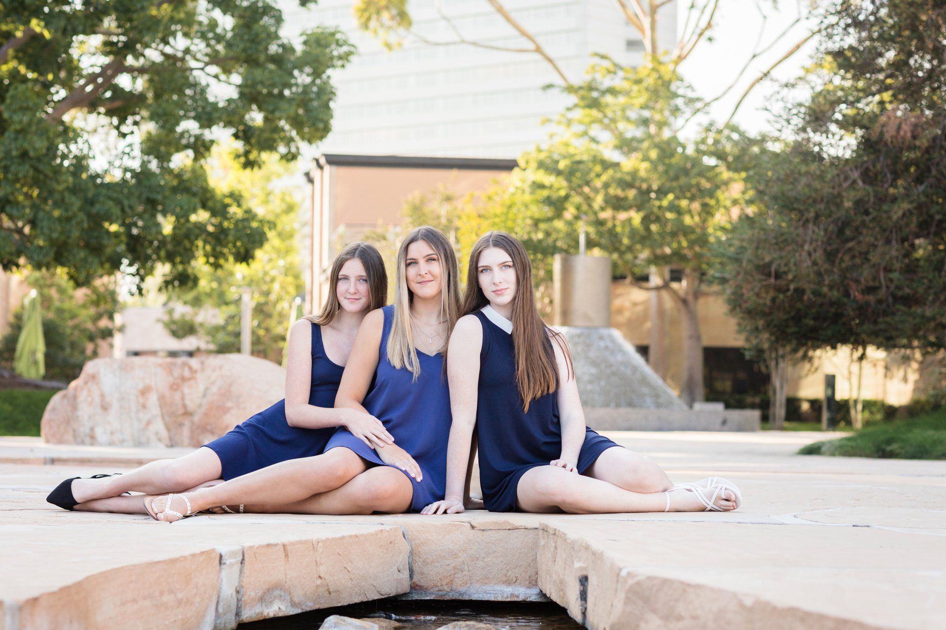 Three sisters posing in Noguchi gardens in Costa Mesa
