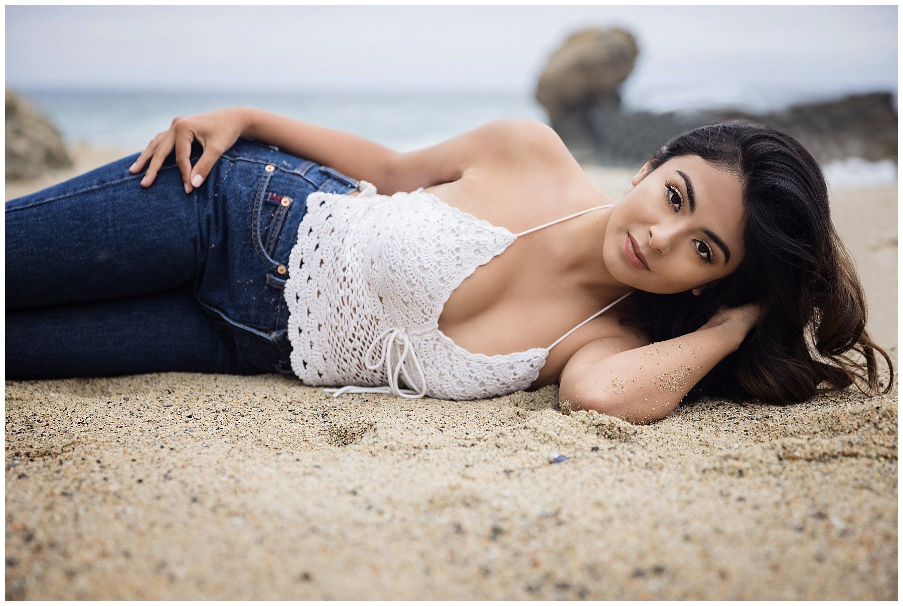 High school senior poses against the stunning backdrop of Tablerock Beach in Laguna Beach