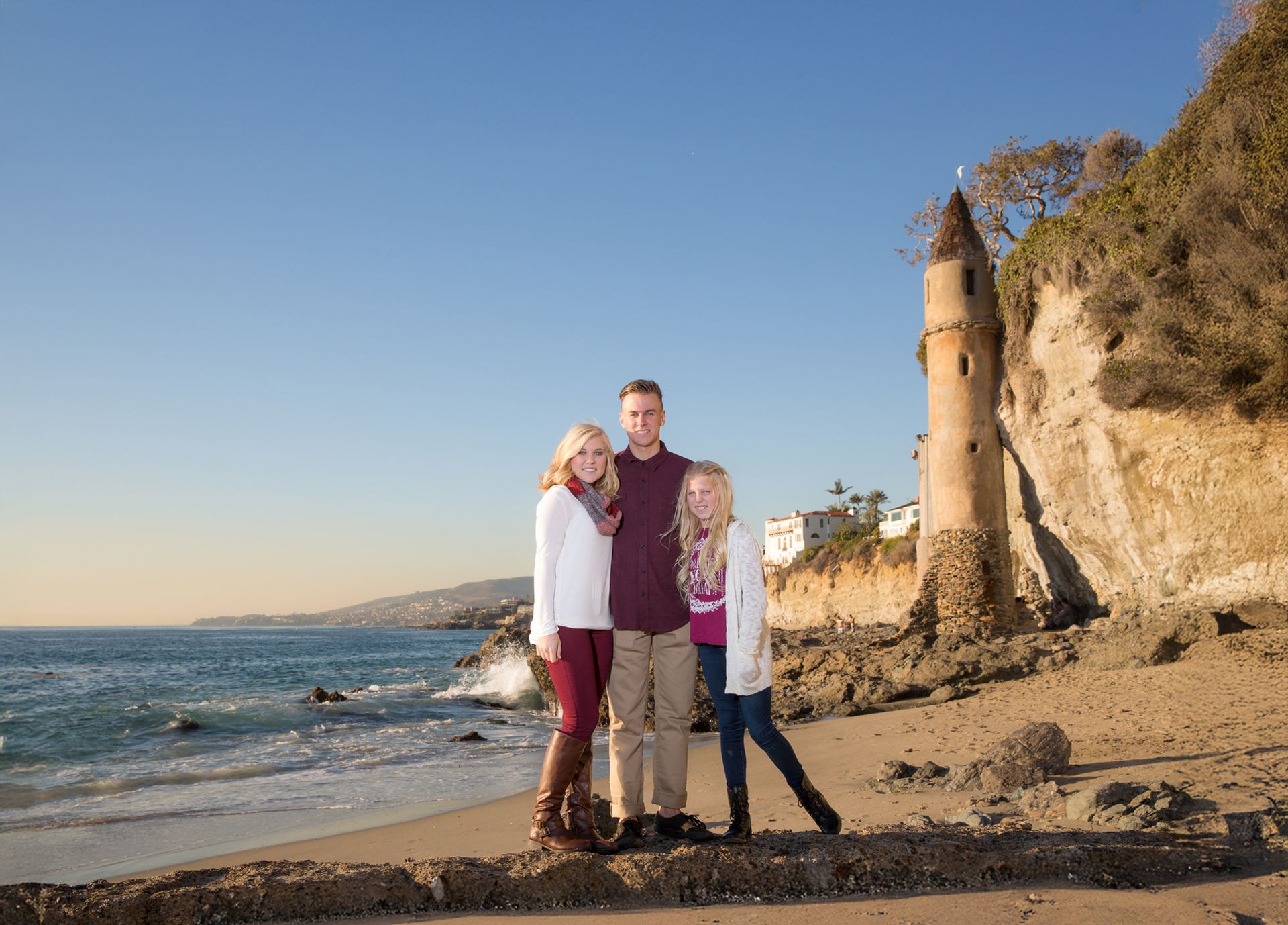 Kids standing on a salt water pool in Victoria Beach with the Pirate Tower in the background.