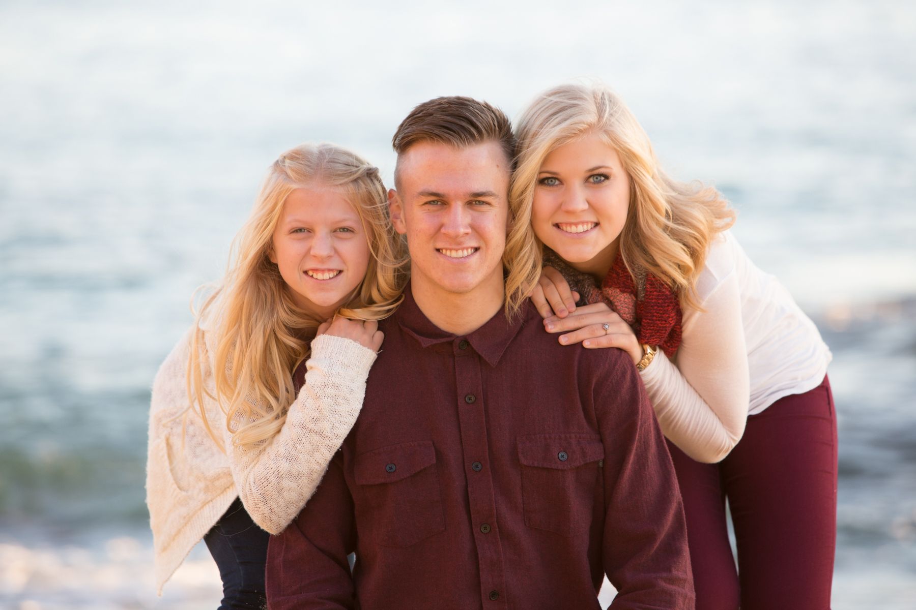 Close up portrait of siblings in Laguna Beach posing in front of the ocean.