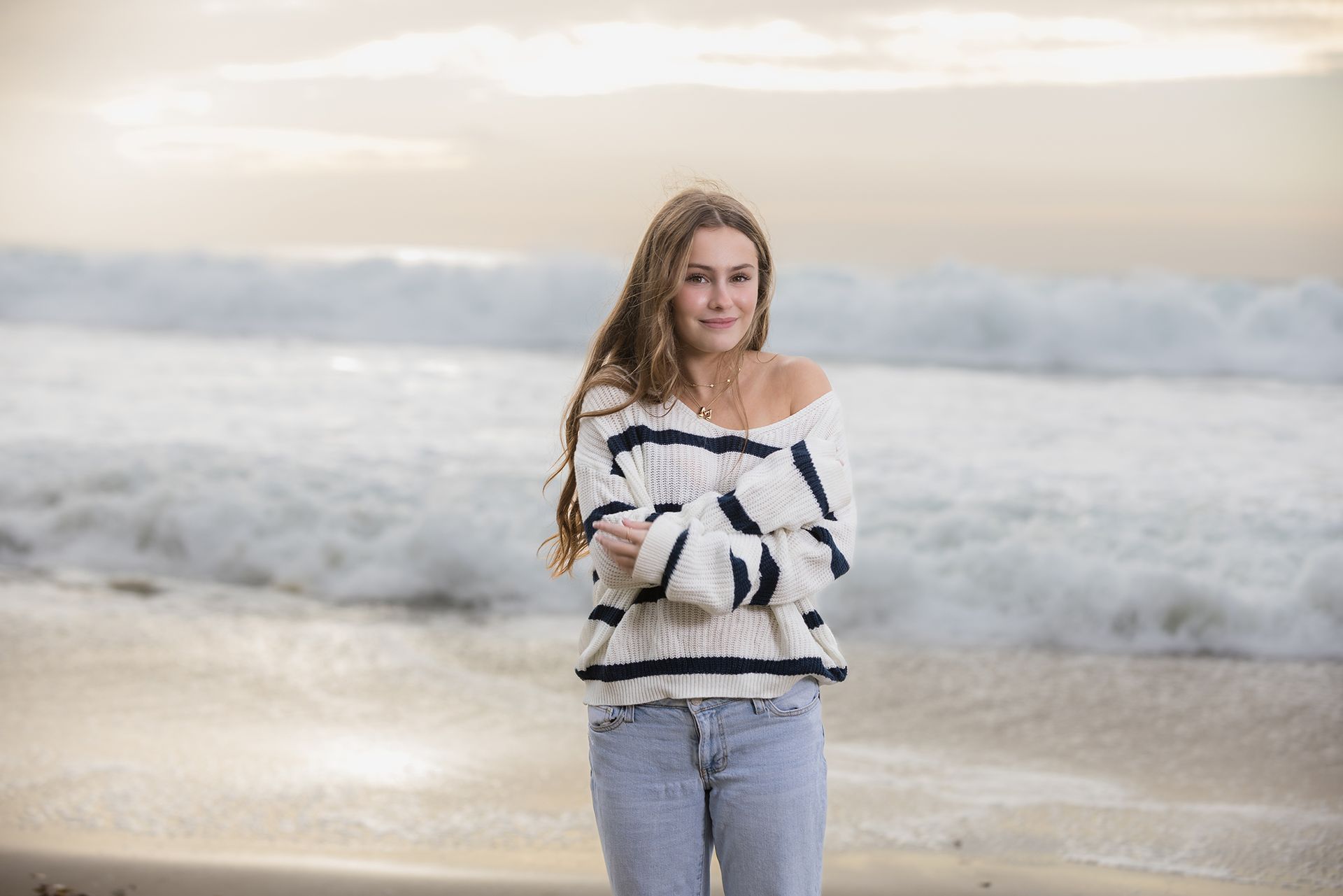Teenage blond girl posing in front of the ocean at sunset in Dana Point.
