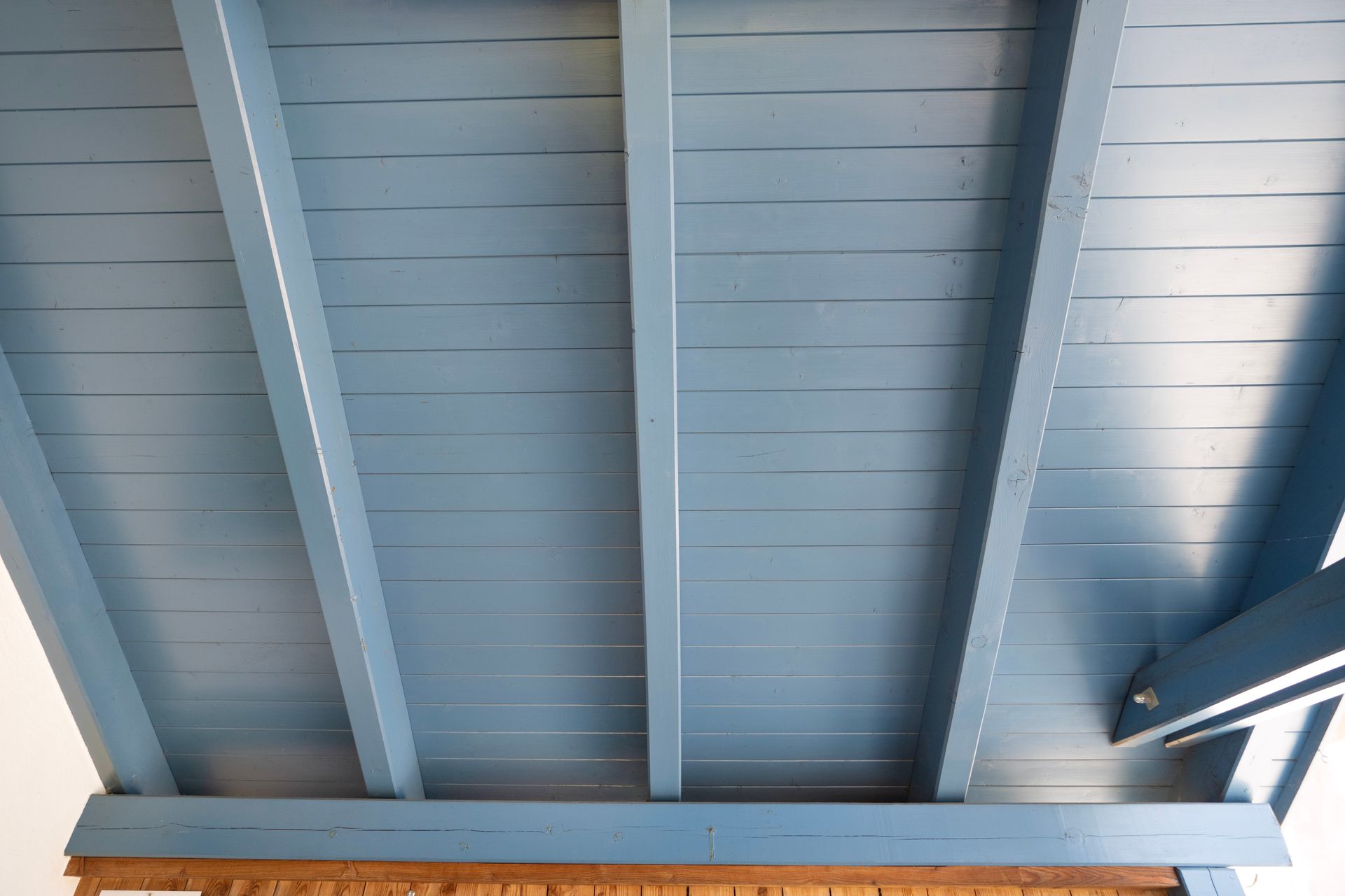 ein blaues Holzdach mit einem weißen Hintergrund