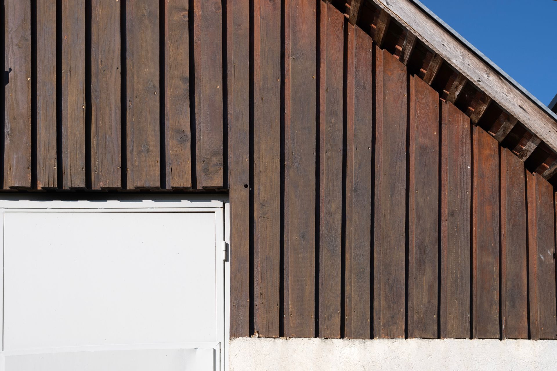 eine Holzwand mit einer weißen Tür darauf