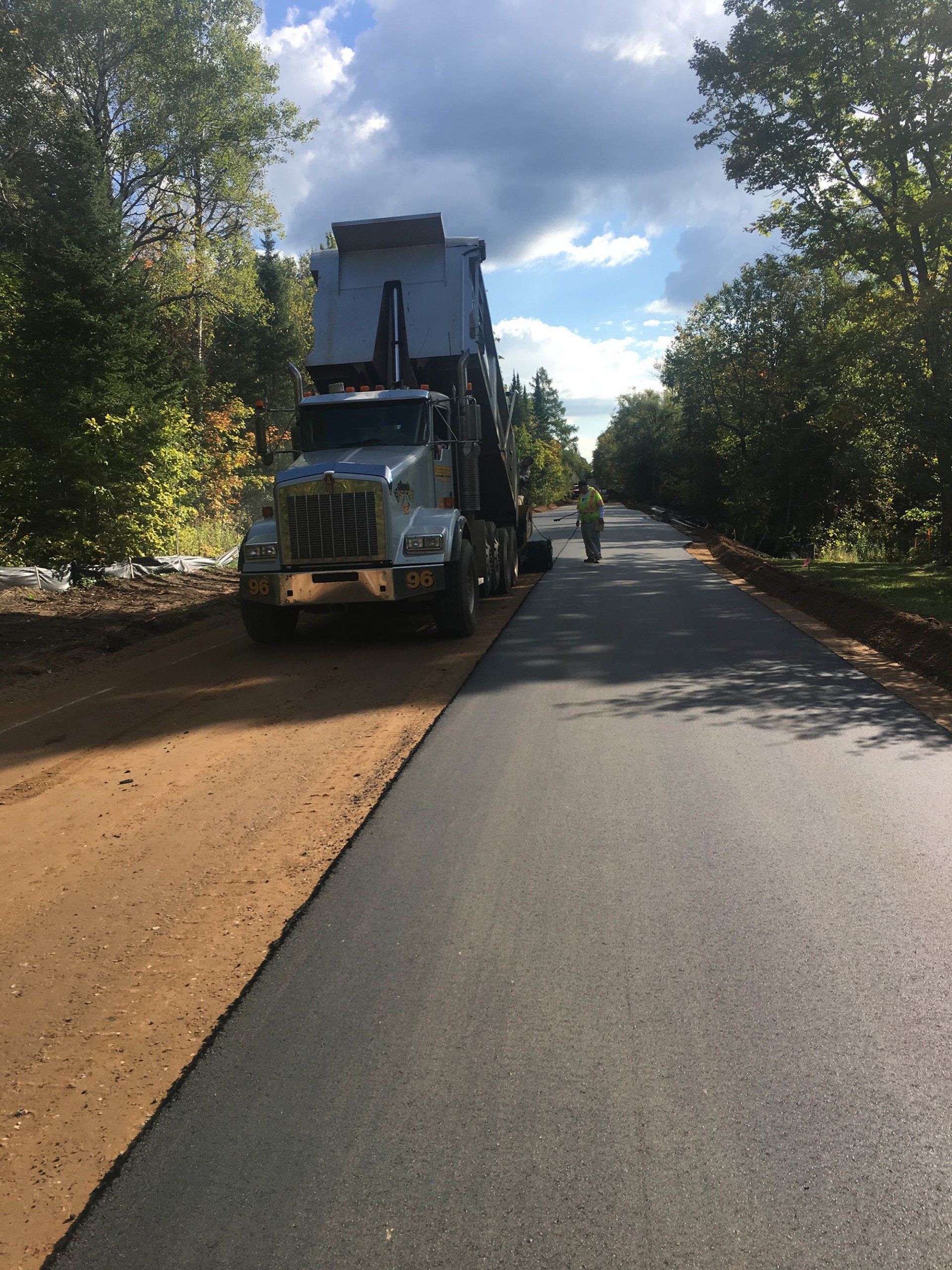 A dump truck is parked on the side of a road