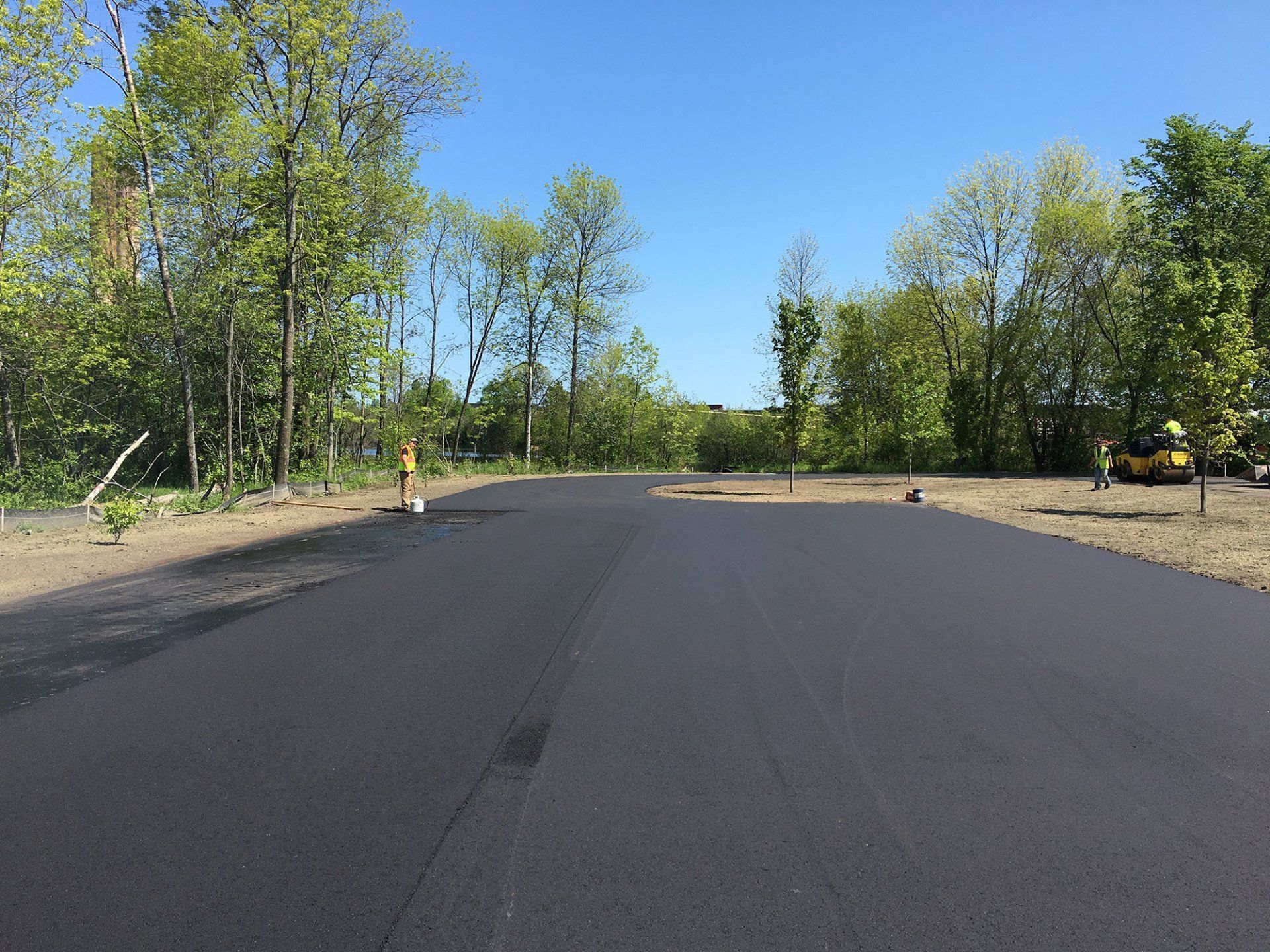 A man is standing on the side of a road.