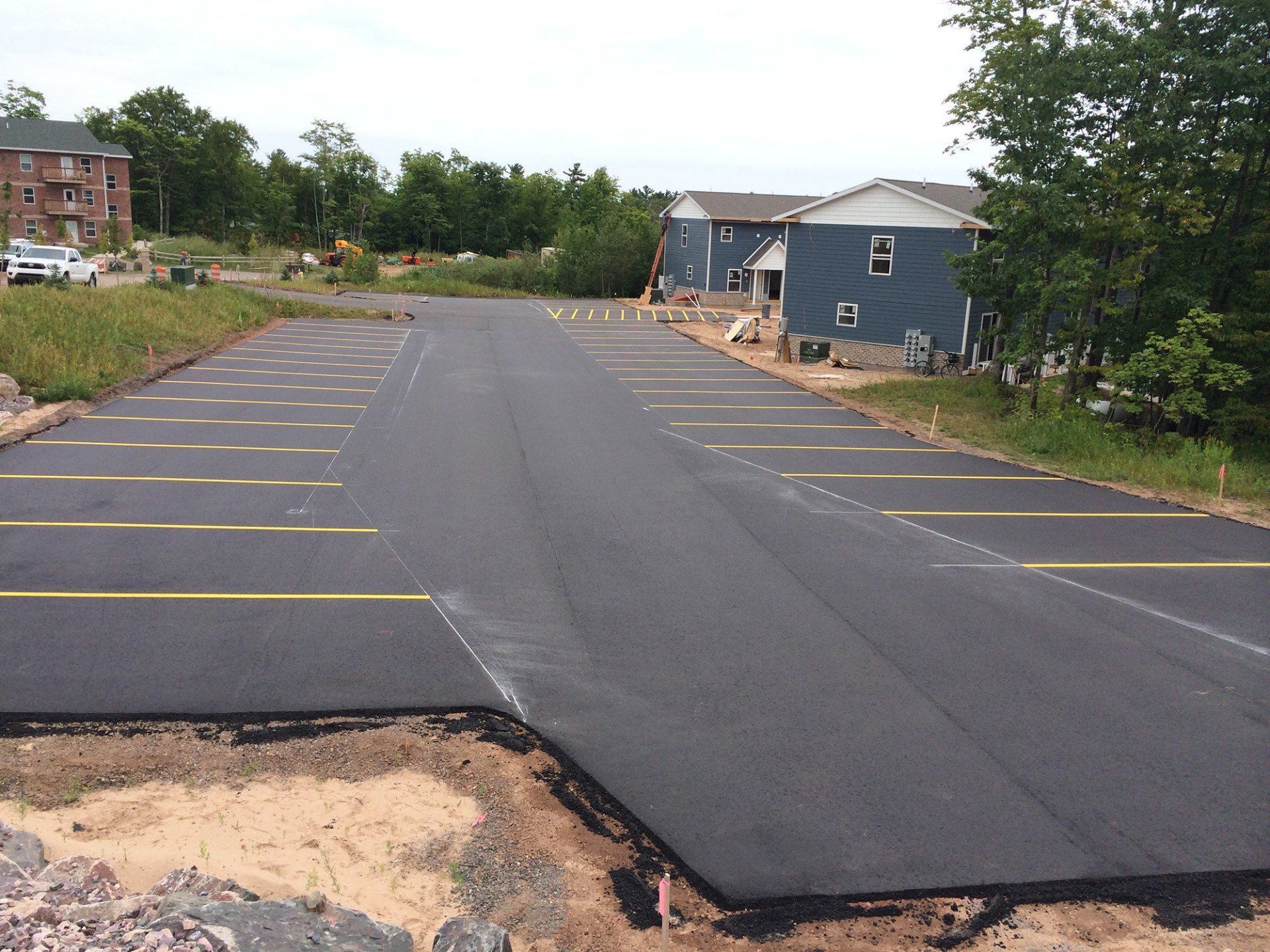 A parking lot with a blue building in the background