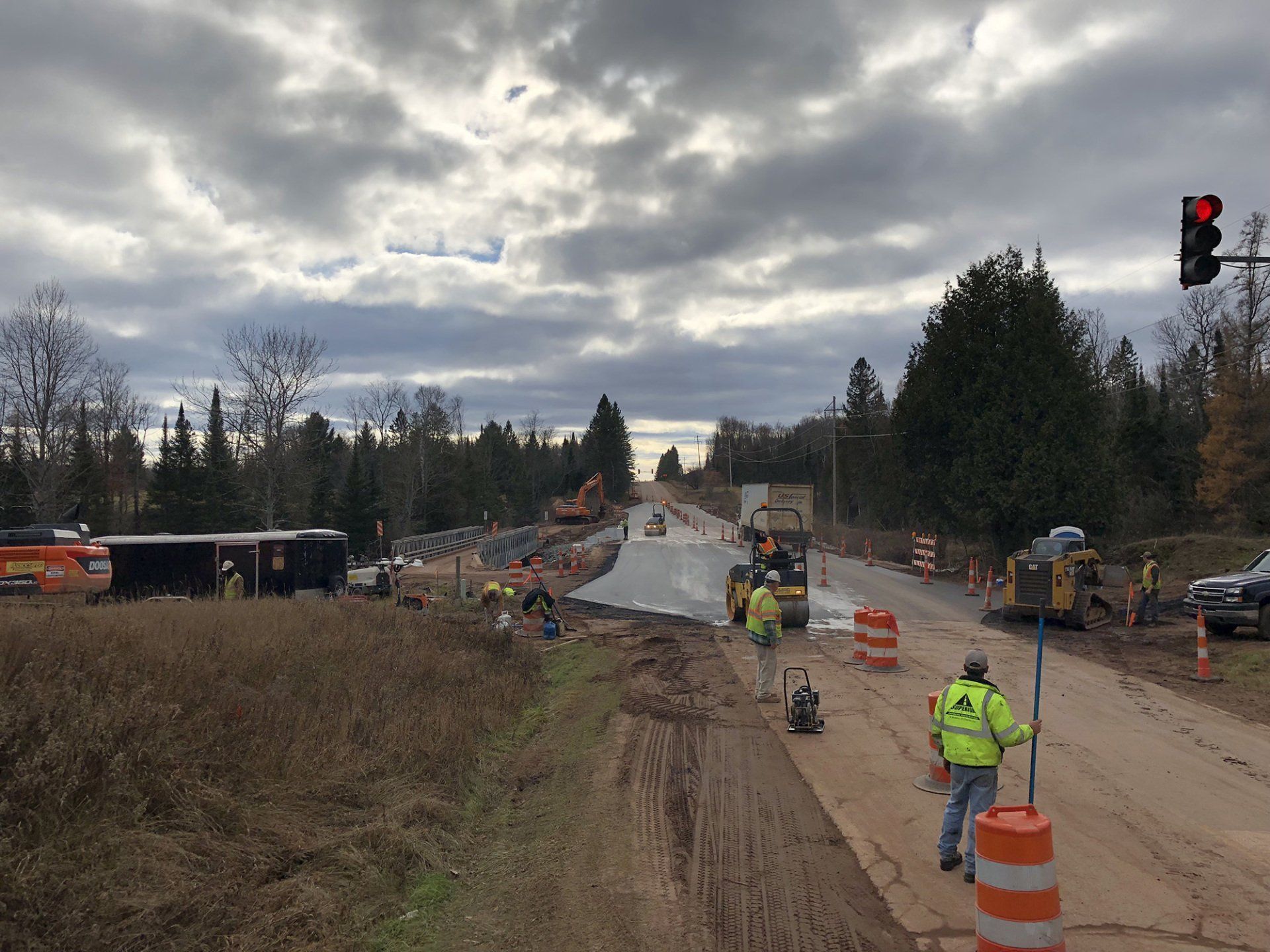 A group of construction workers are working on a road.