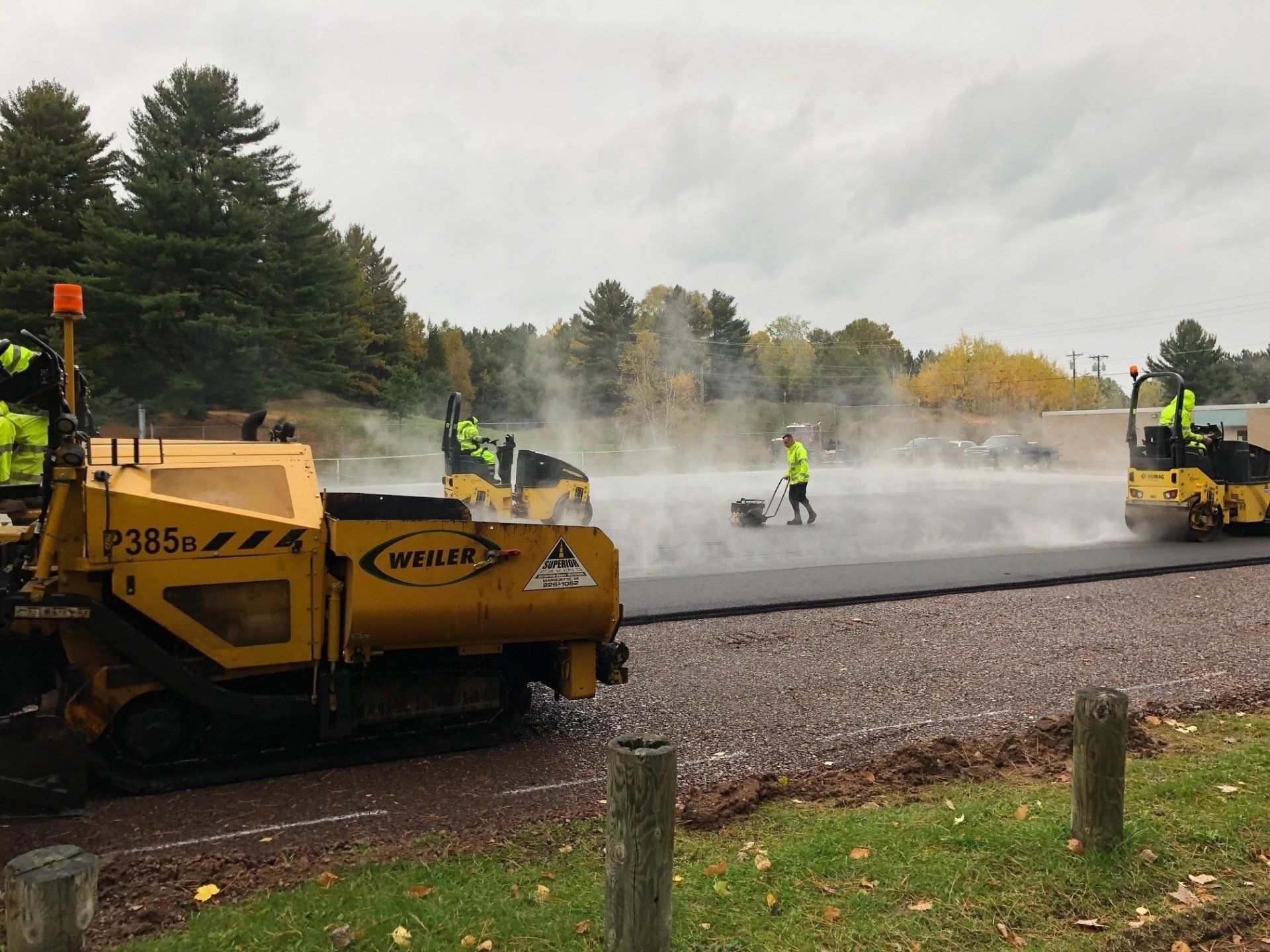 A group of construction workers are working on a road.