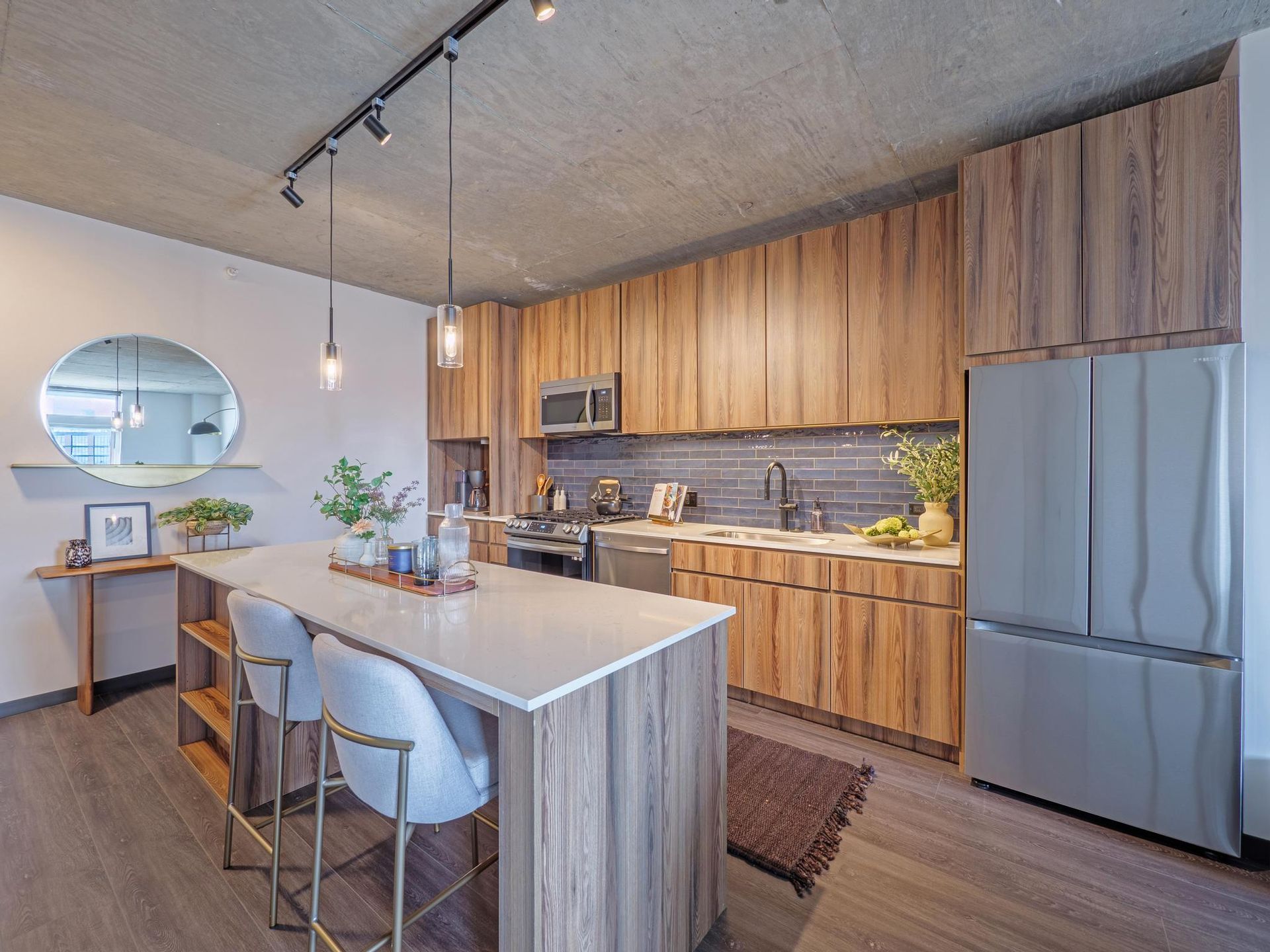 luxury apartment kitchen with island seating and stainless steel appliances