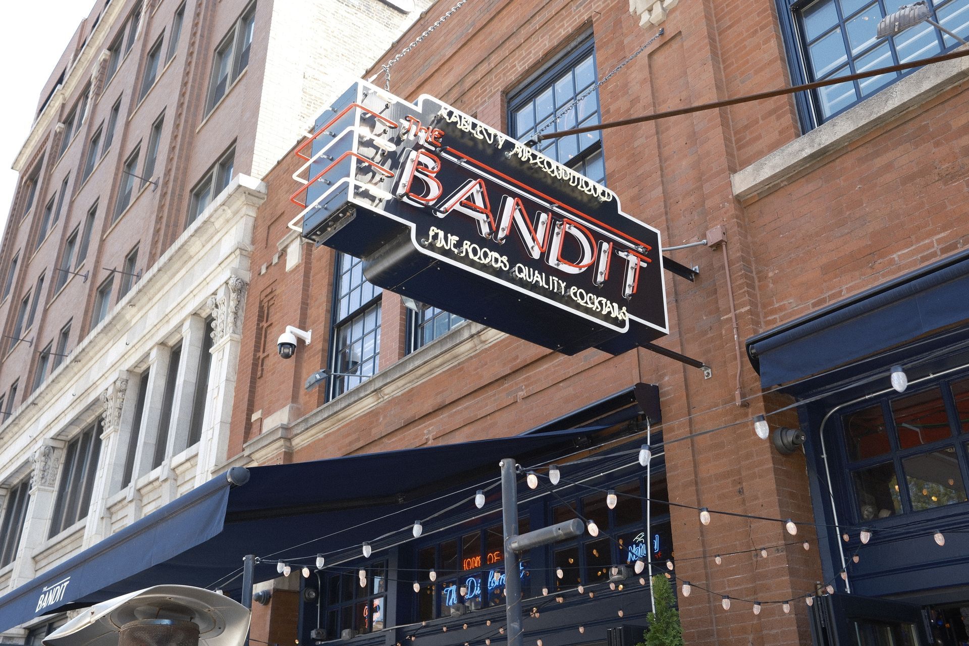 A brick building with a neon sign that says bandit