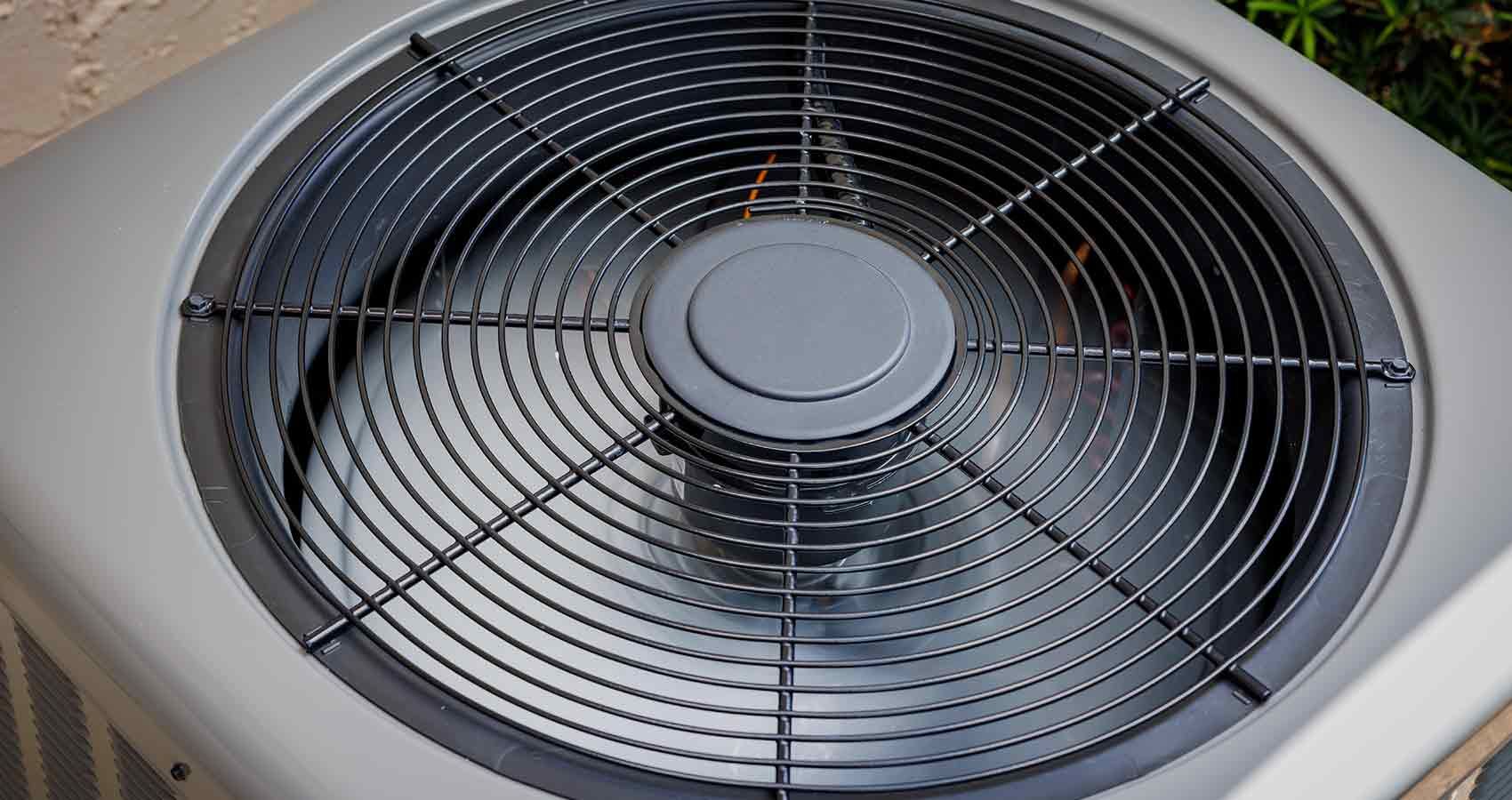 A close up of a fan on a wall.