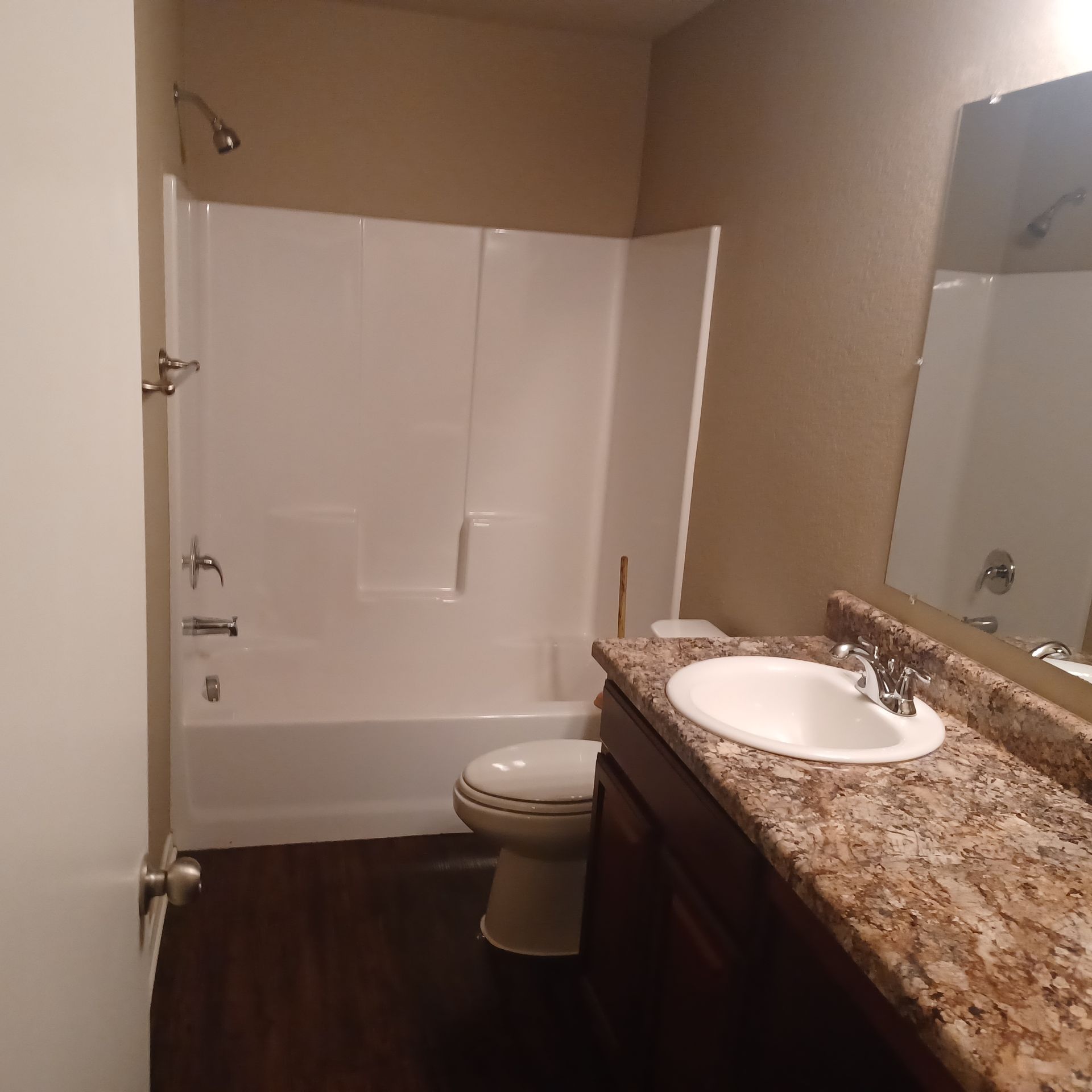 A bathroom with a toilet a sink and a bathtub