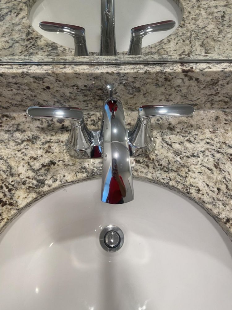 A bathroom sink with a faucet and a mirror — Springdale, AR — Lady Bug Cleaning Services