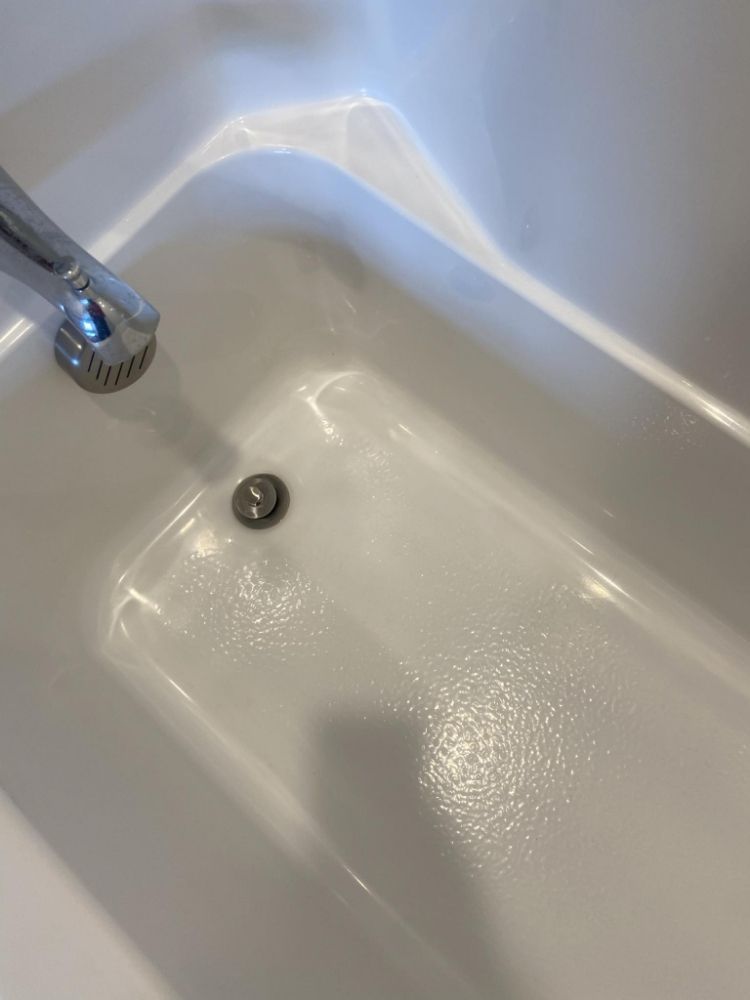 A white bathtub with a chrome faucet and drain — Springdale, AR — Lady Bug Cleaning Services