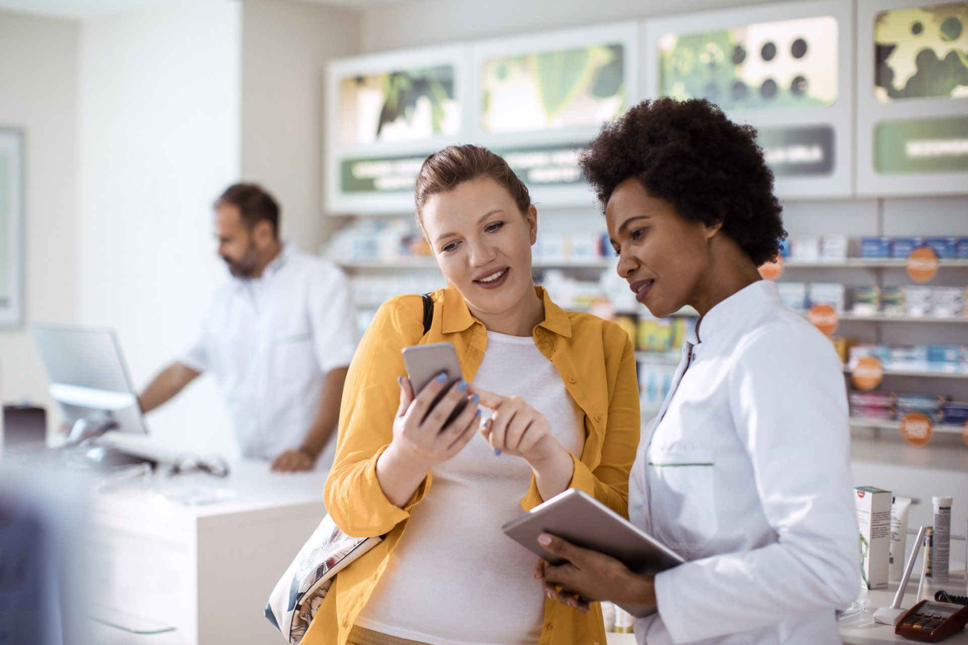 Nurse And Female Patient Looking At Phone — Laurel, MD — Prosperity Clinic