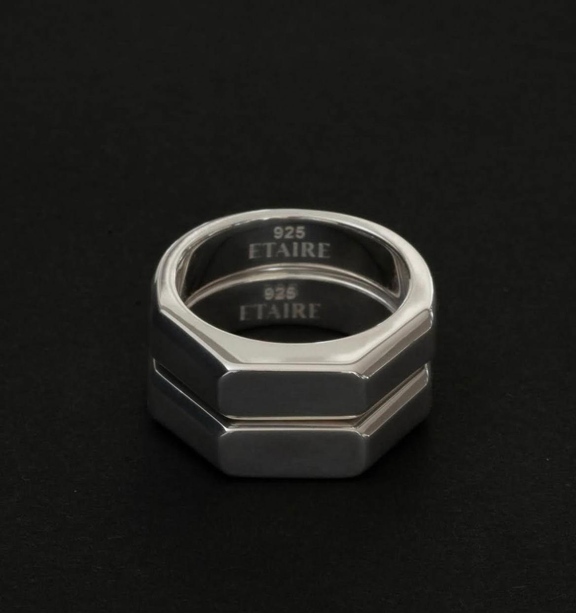 Silver octagonal ring on a black background, with