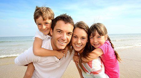 Happy family on beach after receiving loan in Christchurch