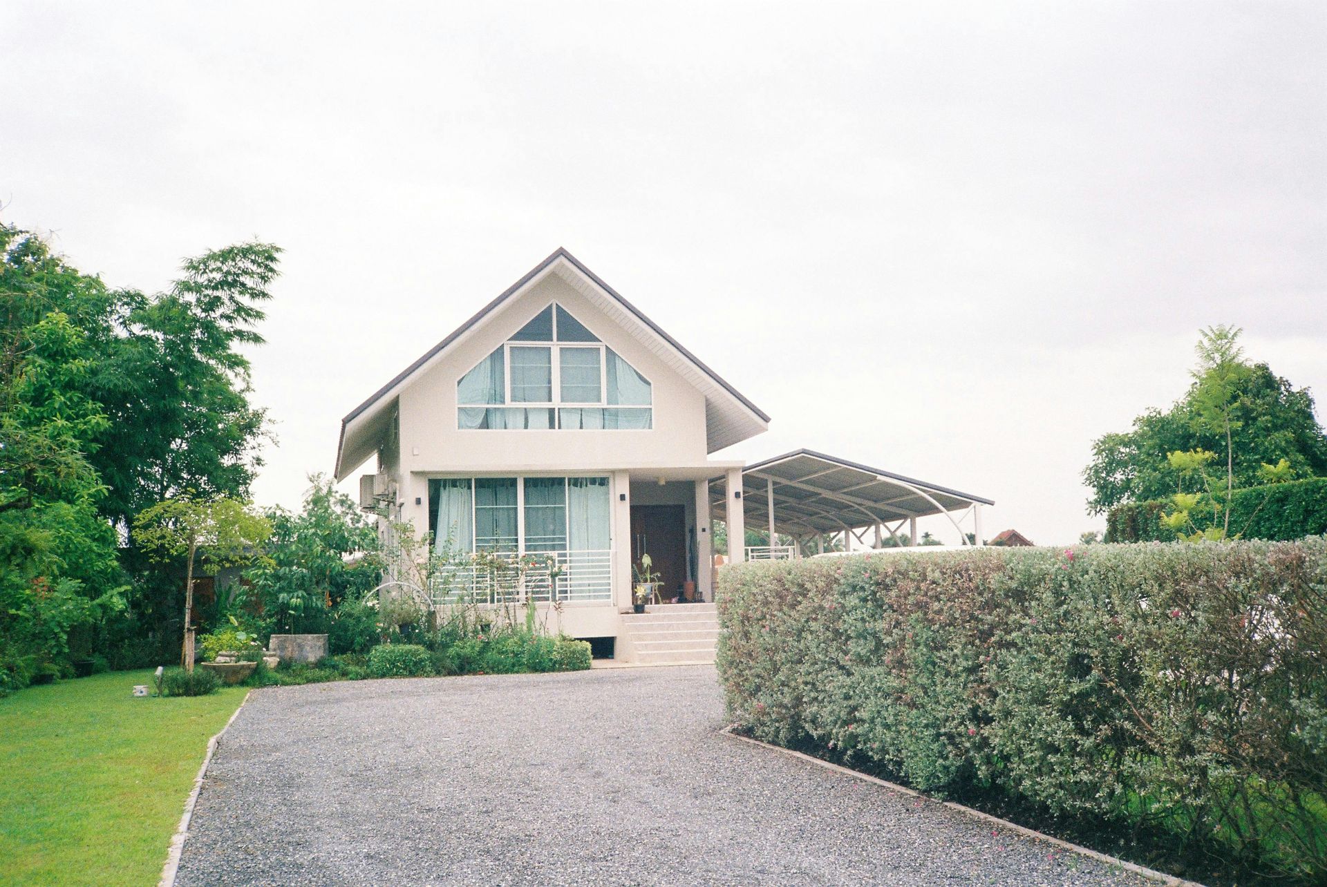 A house with a gravel driveway leading to it