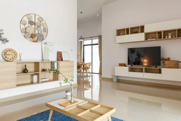 A living room with a coffee table and a flat screen tv.