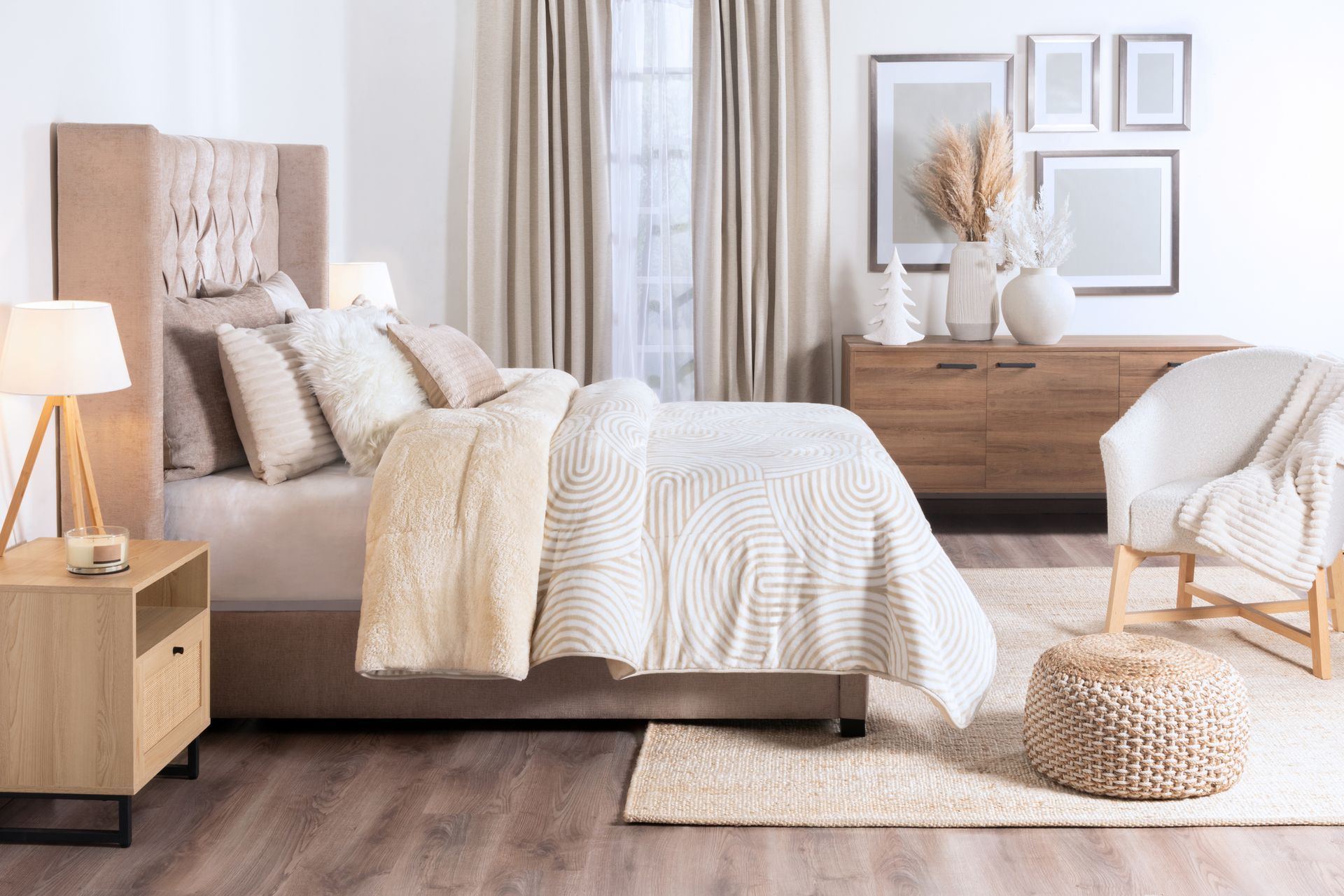 A bedroom with a bed , nightstand , chair and dresser.