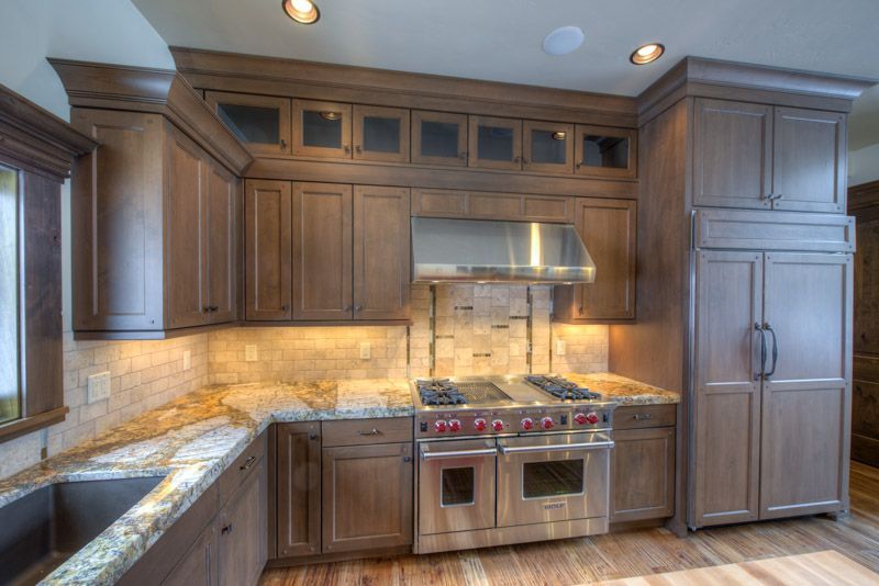 A kitchen with stainless steel appliances and wooden cabinets