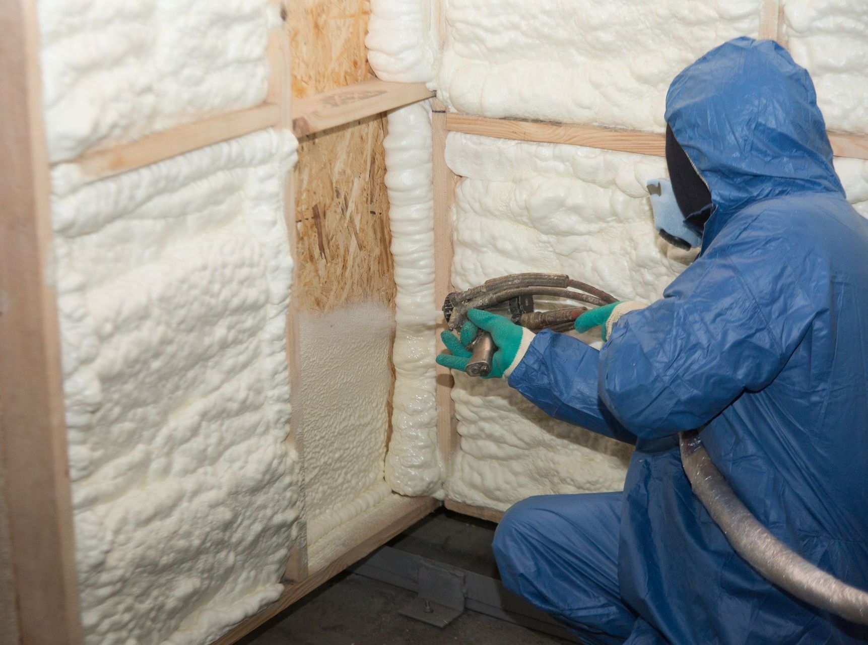Burlington Queen City Spray Foam Contractor spraying insulation into walls