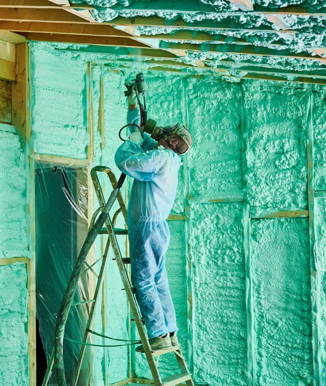 Spray  Foam Insulation Contractor spraying insulation into attic in Burlington VT Home