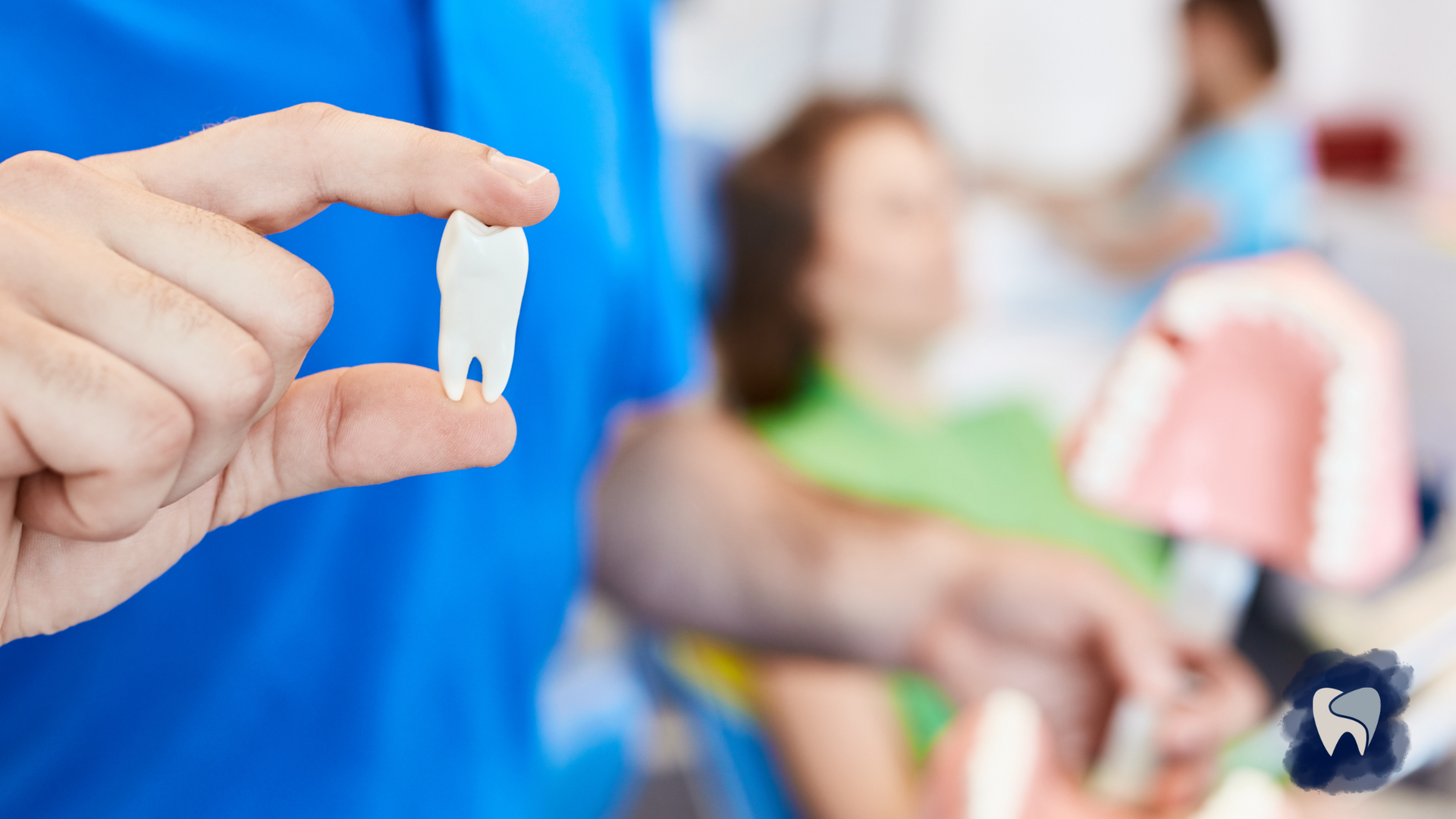 Dentist holding an extracted tooth in front of a patient in a dental office.