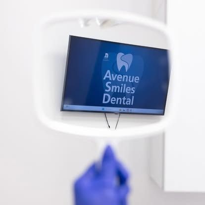 A dental clinic television screen with the 