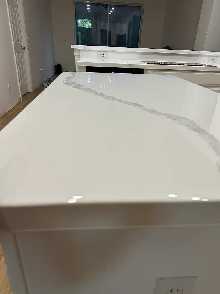 White kitchen countertop with a gray veining detail.