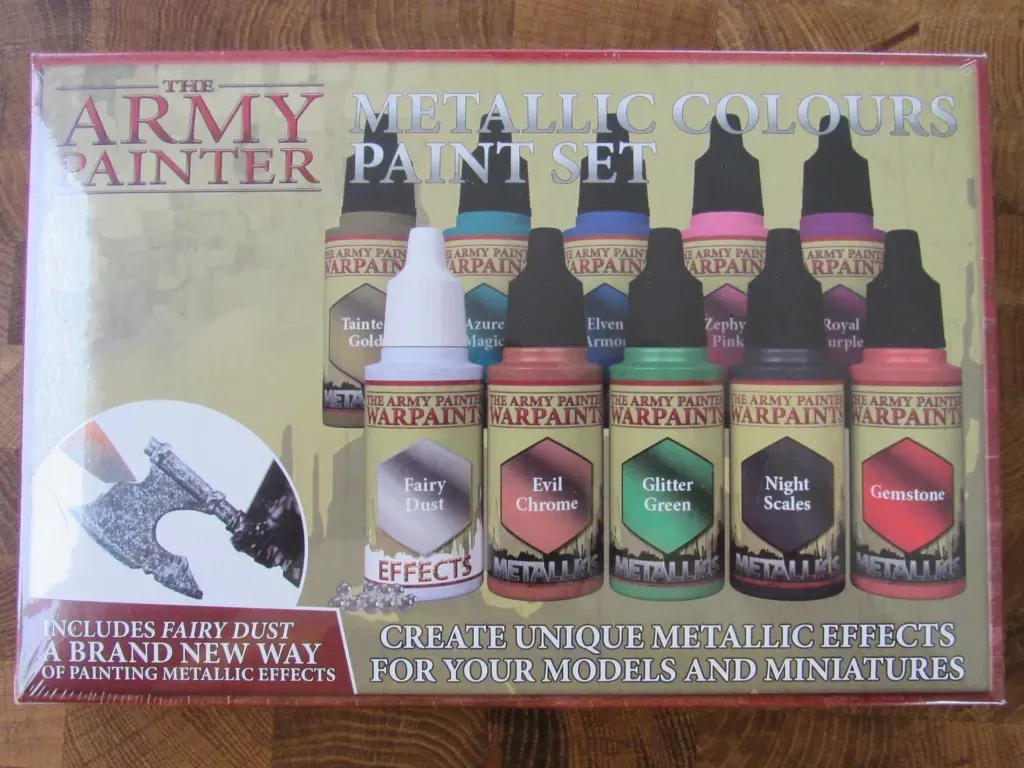 Army Painter metallic paints set in a box. Various colored bottles: gold, silver, copper, green, blue, pink and red.