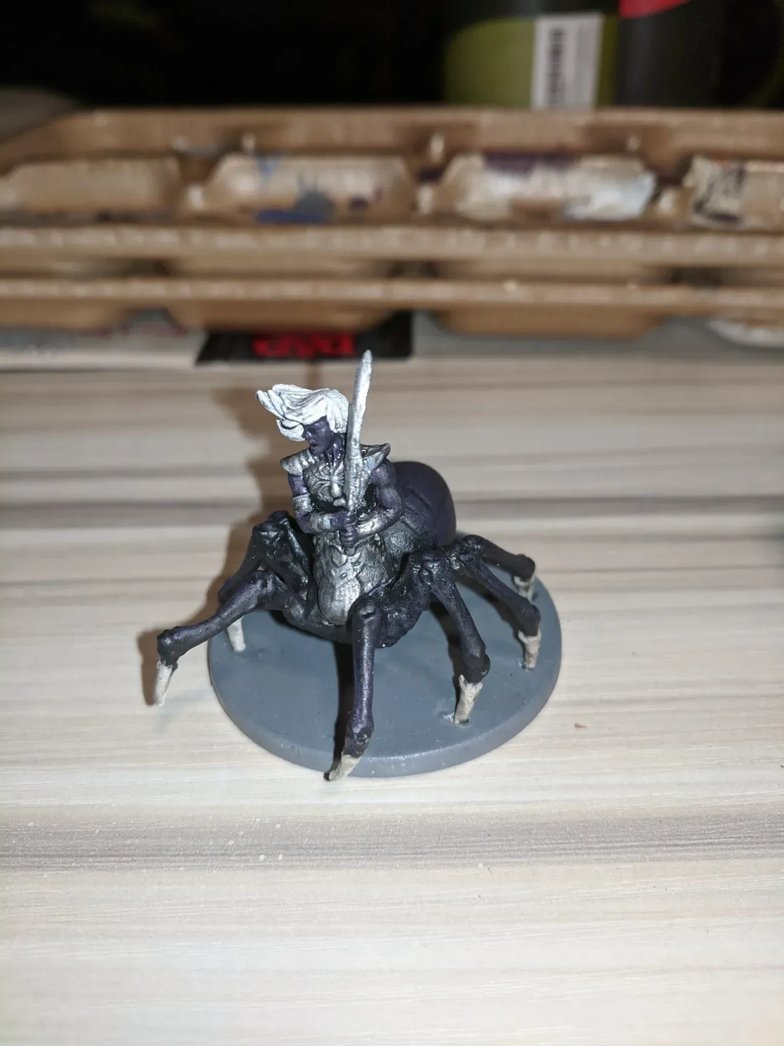Miniature spider-mounted knight, black and silver, on a gray base.