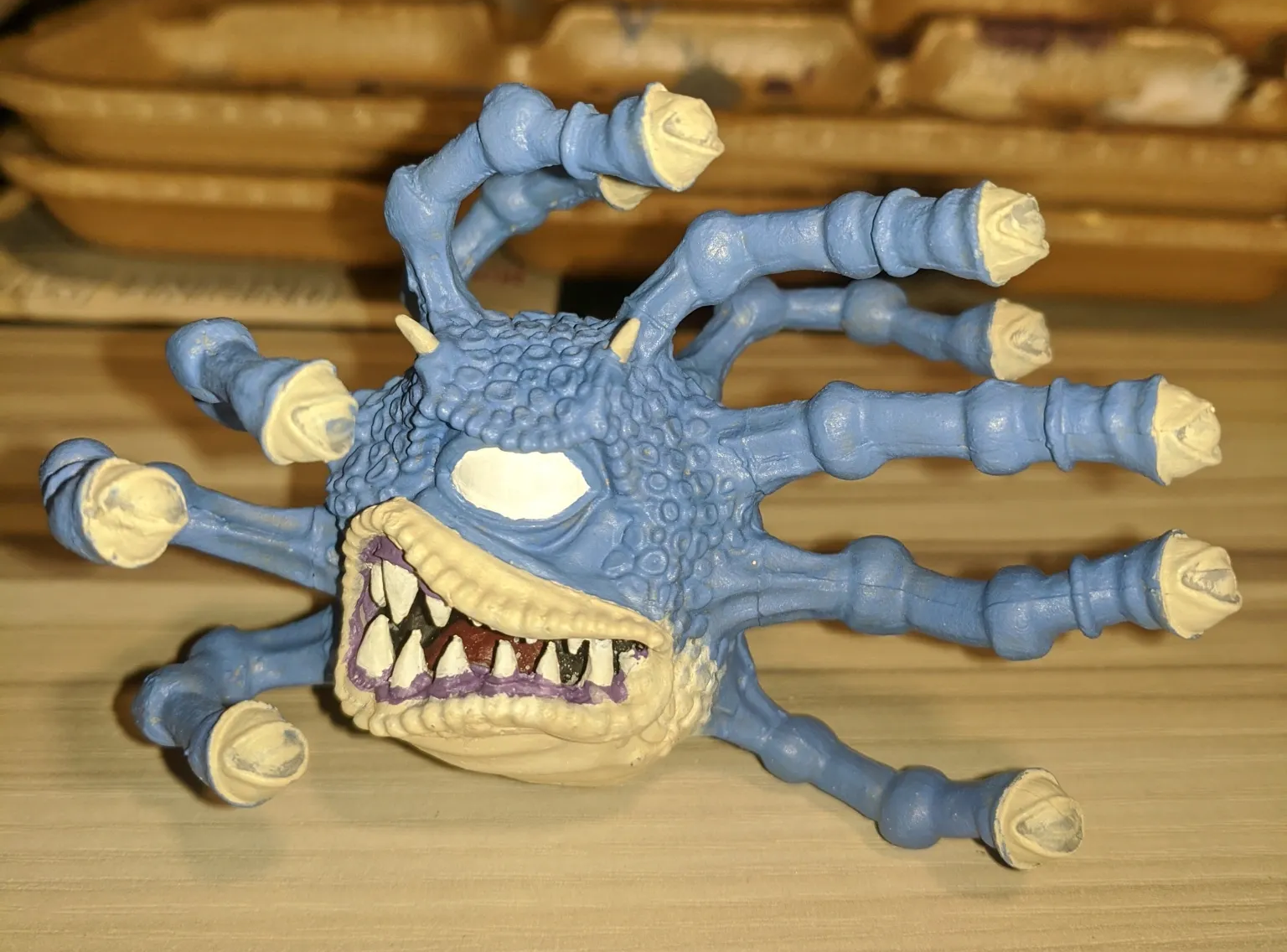 Blue monster with multiple eye stalks, sharp teeth, and an angry expression.