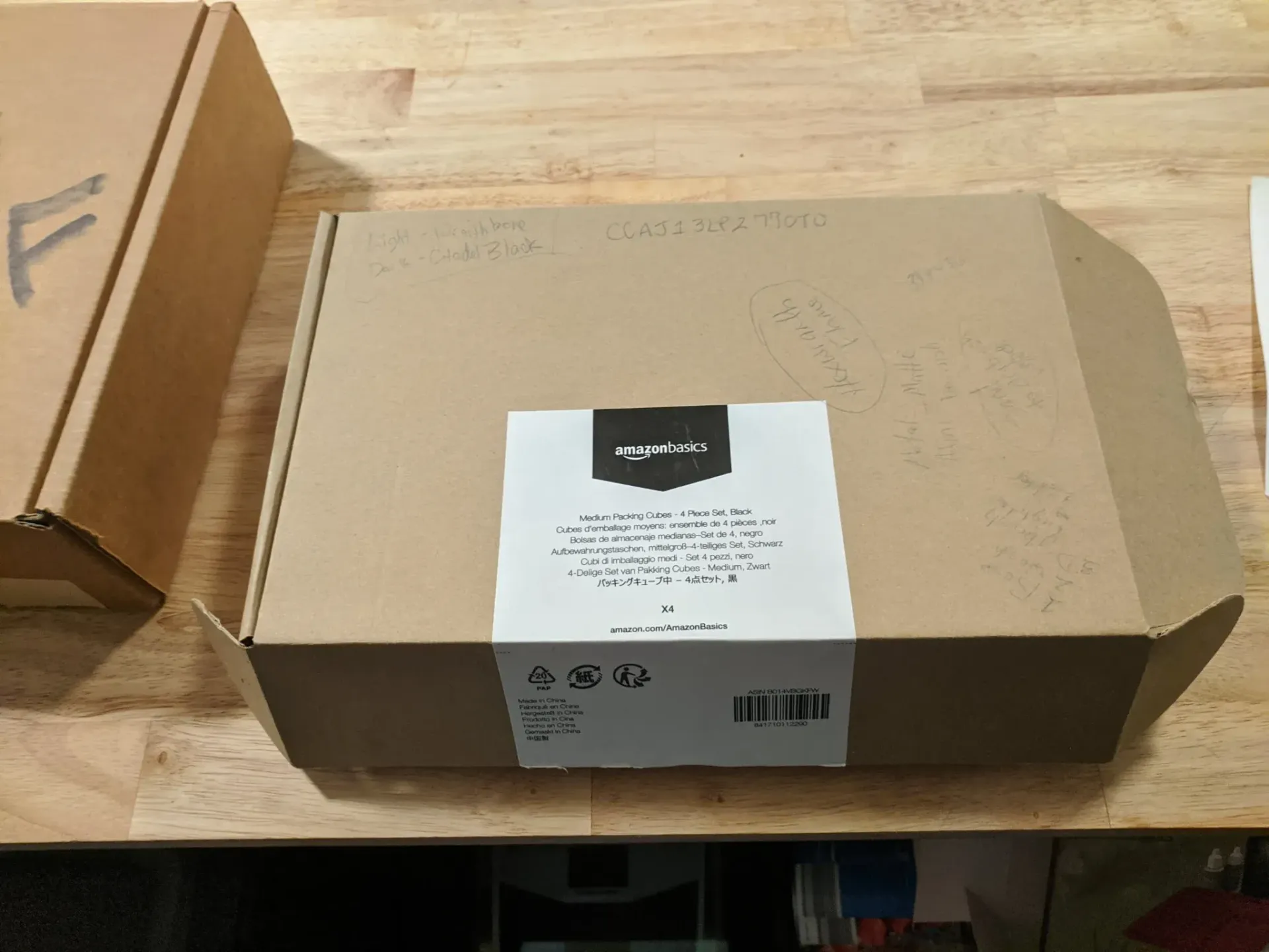Cardboard box with shipping label on a wooden surface.