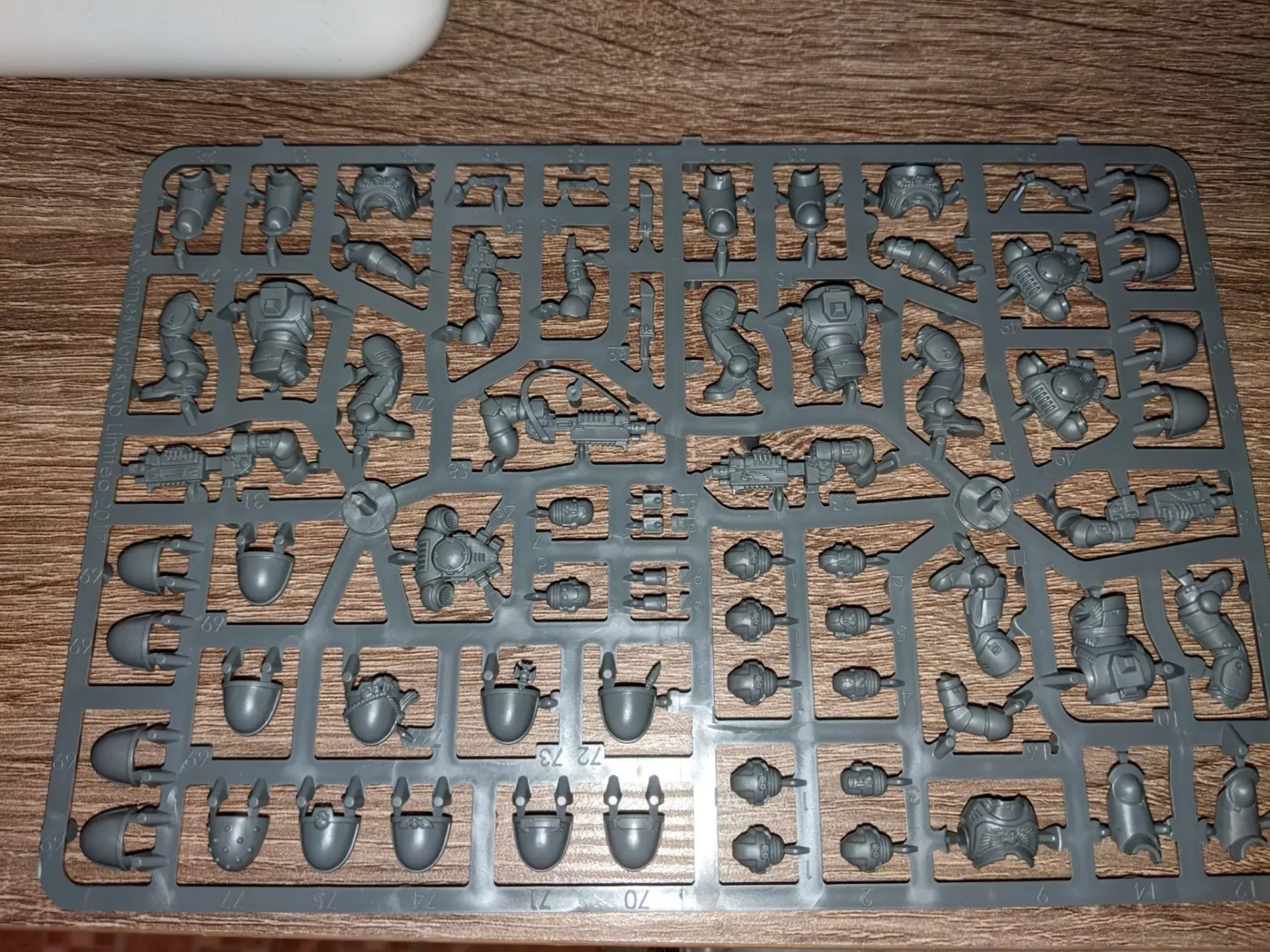 Plastic model sprue with various pieces for miniature figures. Gray plastic, hobby-related.