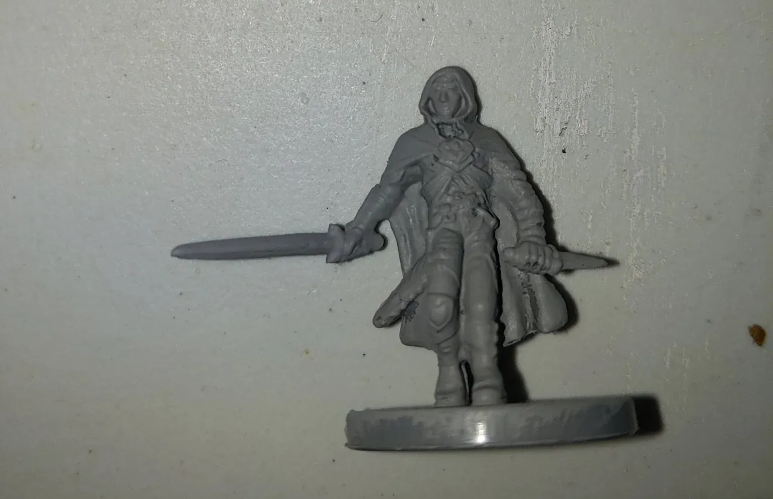 Miniature figure of a person with sword in hand.