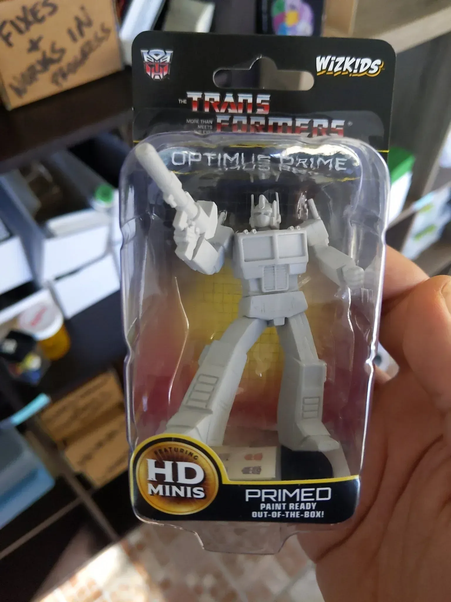 Optimus Prime HD Mini figure in packaging, grey color, holding a blaster.