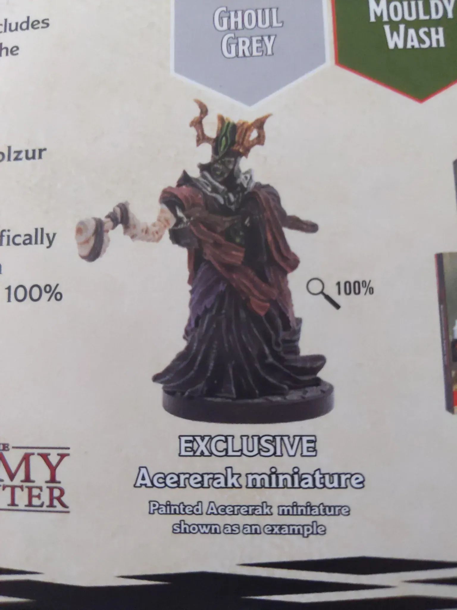 Acererak miniature, grey and purple robes, holding a staff.