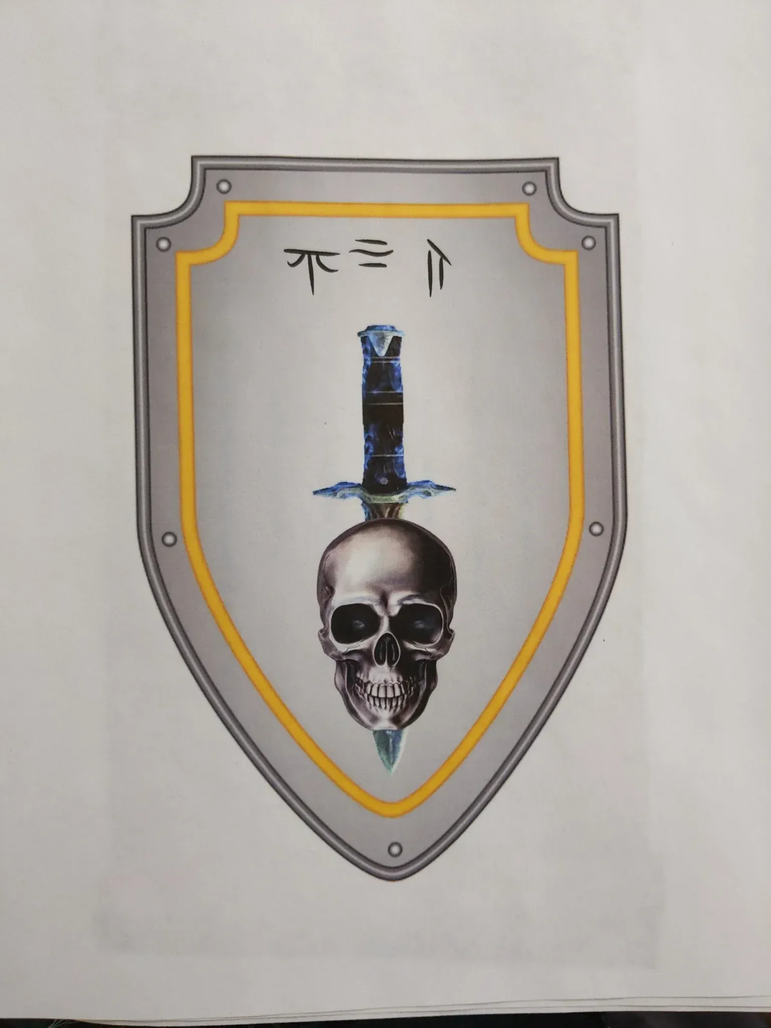 Shield with skull impaled by a sword, surrounded by gold trim. Top has two symbols.