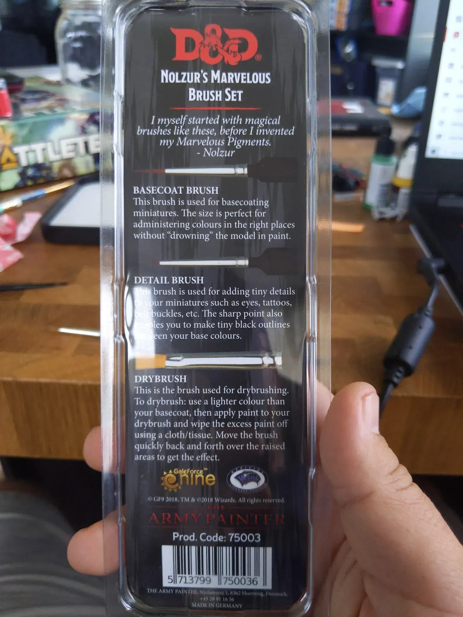 Back of D&D paint brush set held by a person. Black packaging with white text, barcode.