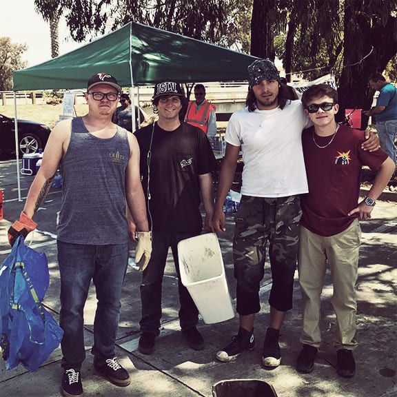 A group of young men standing under a green tent