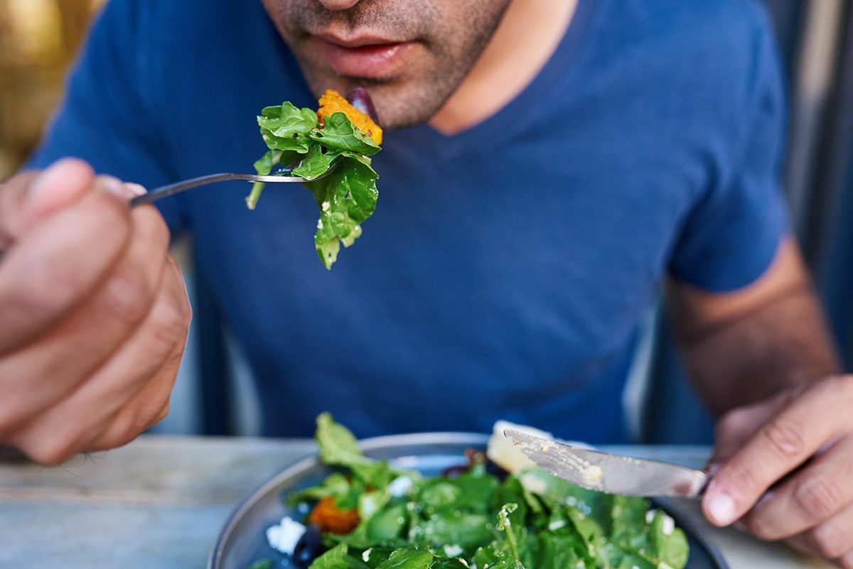 man eating a salad