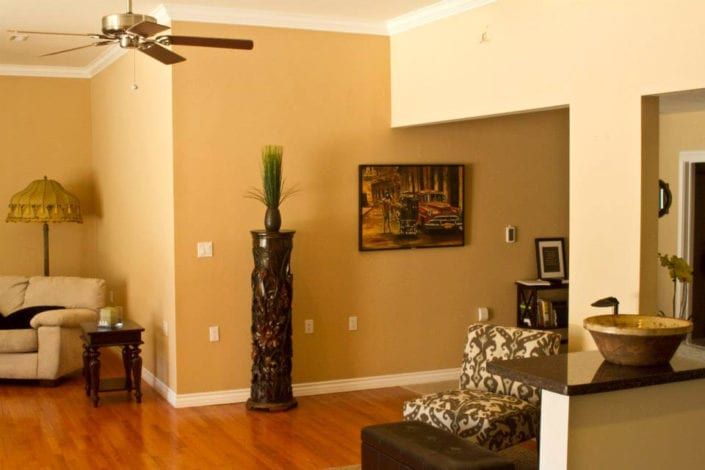 A living room with hardwood floors and a ceiling fan