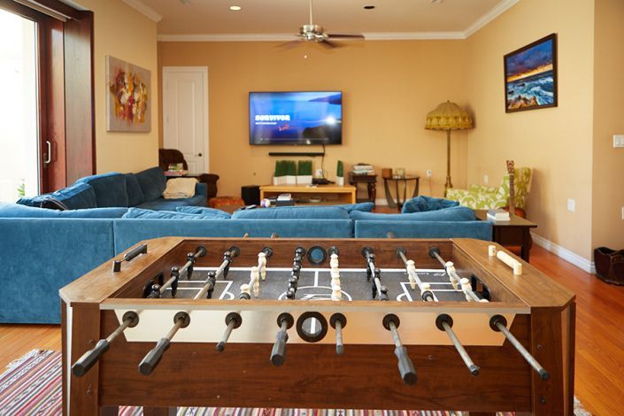 A foosball table is in the middle of a living room