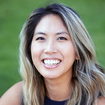 A woman with long blonde hair is smiling for the camera.