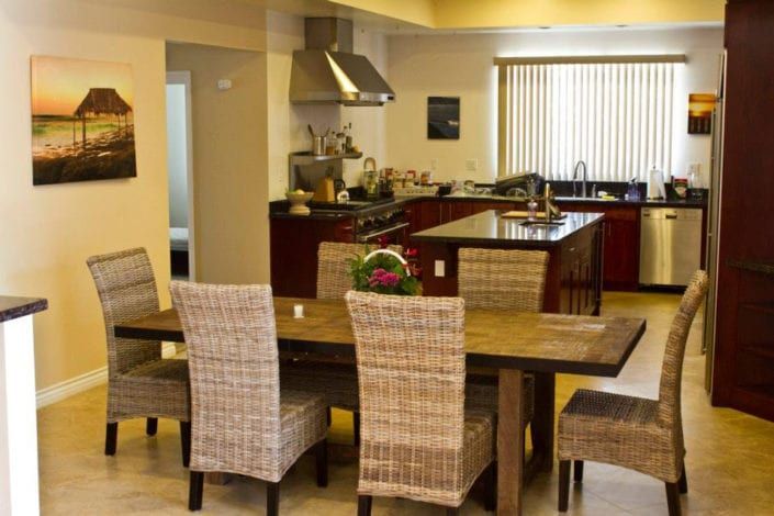 A kitchen with a table and chairs in it