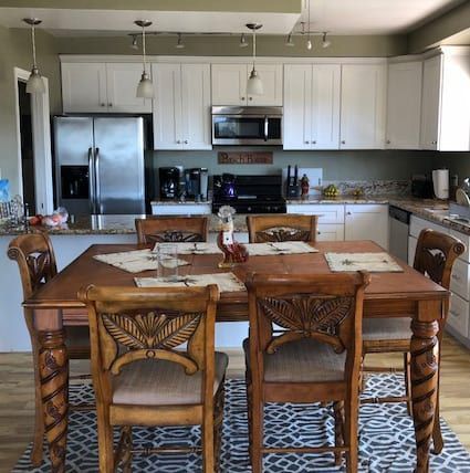 A kitchen with a table and chairs in it