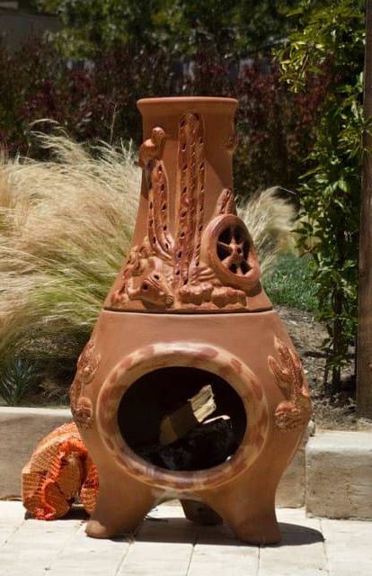 A clay fireplace with a cactus design on it