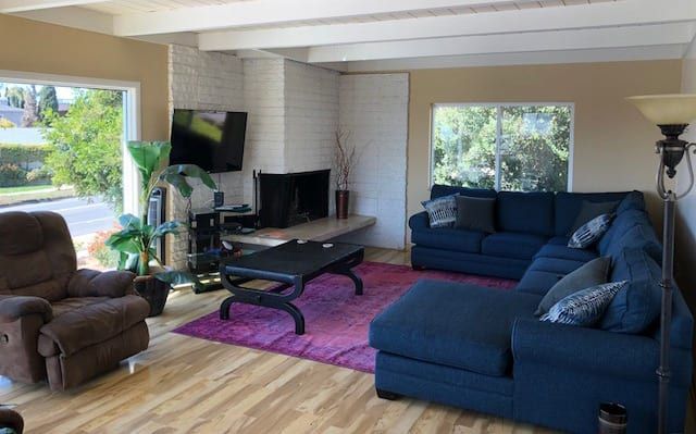 A living room filled with furniture and a fireplace.